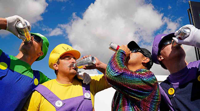 Fans drink beer watching the 10th hole during the third round at the WM Phoenix Open at TPC Scottsdale.